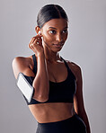 Fitness, music and woman in studio for exercise, wellness and advertising on grey background space. Workout, mockup and girl relax with podcast, audio for track for motivation while training isolated