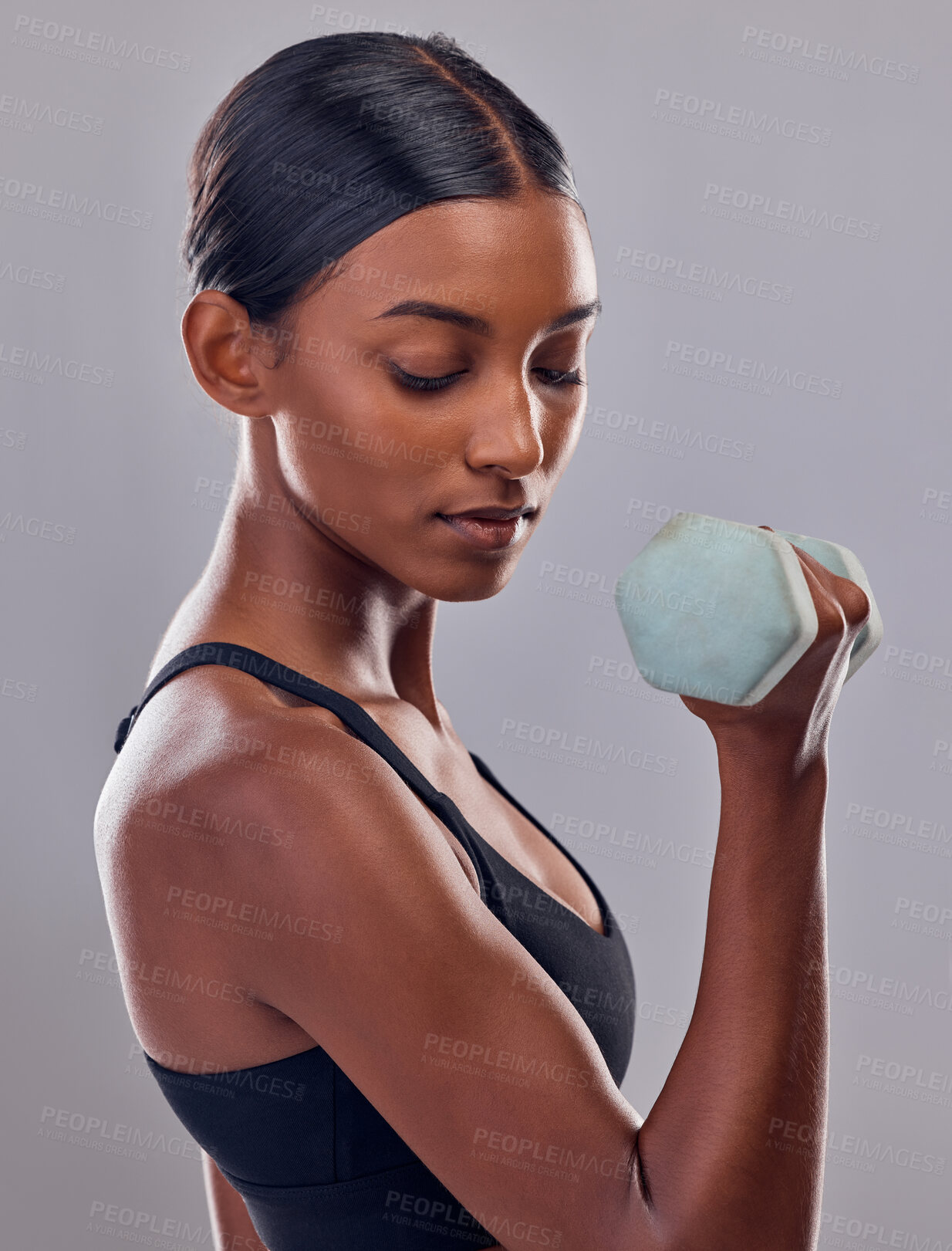 Buy stock photo Woman, bicep and dumbbell training in studio for strong body, action and wellness goals. Indian female, bodybuilder and weights of fitness, power exercise and muscle energy for healthy sports workout