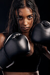 Boxing, gloves and portrait of woman on black background for sports, strong focus or mma training. Female boxer, workout or fist fight of impact, energy and warrior power for studio fitness challenge