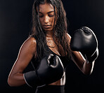 Boxing, gloves and sweating with a sports woman getting ready in studio on a black background for fitness. Exercise, health and sweat with a female athlete or boxer training during a combat workout