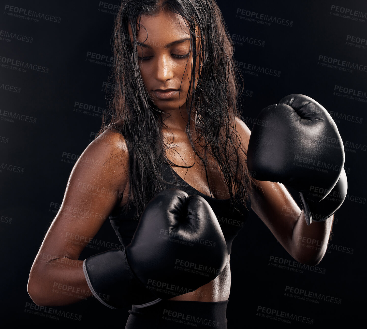 Buy stock photo Boxing, gloves and sweating with a sports woman getting ready in studio on a black background for fitness. Exercise, health and sweat with a female athlete or boxer training during a combat workout