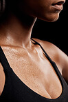 Fitness, sweat and chest of a woman in a studio after an intense workout or sport training. Sports, health and healthy female athlete sweating after a health gym exercise by a black background.