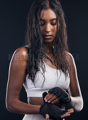 Buy stock photo Boxing, gloves and sweat with a sports woman getting ready in studio on a black background for fitness. Exercise, health and training with a female athlete or boxer sweating during a combat workout