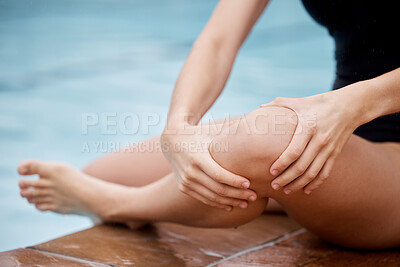 Buy stock photo Hands, knee injury and swimming pool with a woman holding her joint in pain after a sports workout. Fitness, water and anatomy with a female swimmer suffering from an injured leg during exercise