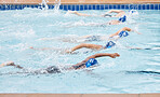 Training, sports or team in swimming pool or water for practice, cardio workout or body fitness. Fast women, speed or healthy group of athletes exercising in a race for endurance or exercise goals