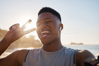 Buy stock photo Selfie, fitness and peace with a black man on the beach for a cardio or endurance workout during summer. Portrait, hand sign and exercise with a male athlete or runner outdoor for marathon training