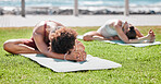 Women, yoga friends and stretching on lawn for wellness, strong legs and body goals by ocean in morning. Woman teamwork, fitness and exercise on grass with support, focus and mindfulness in summer