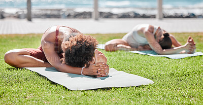 Women, yoga friends and stretching on lawn for wellness, strong legs and  body goals by ocean in morning. Woman teamwork, fitness and exercise on  grass with support, focus and mindfulness in summer