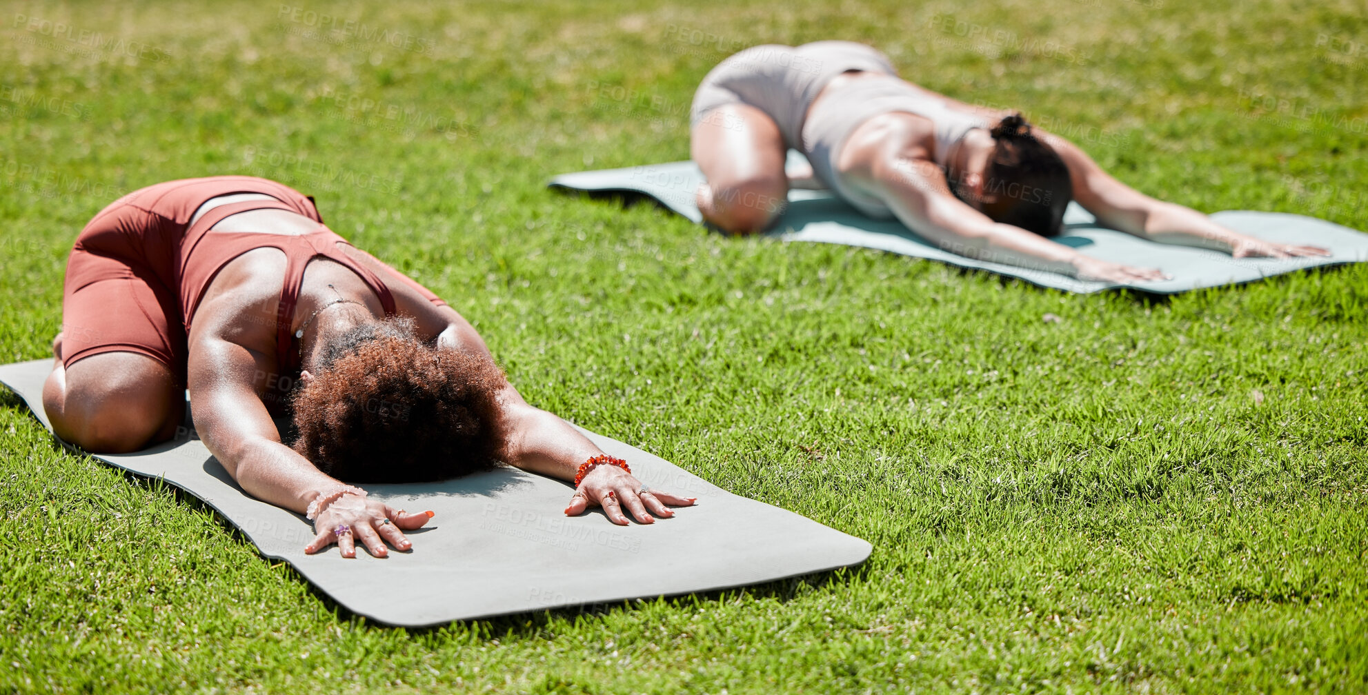 Buy stock photo Fitness, yoga and wellness with woman friends stretching on a field of grass outdoor for spiritual health. Exercise, pilates or downward dog with a female yogi and friend training together outside