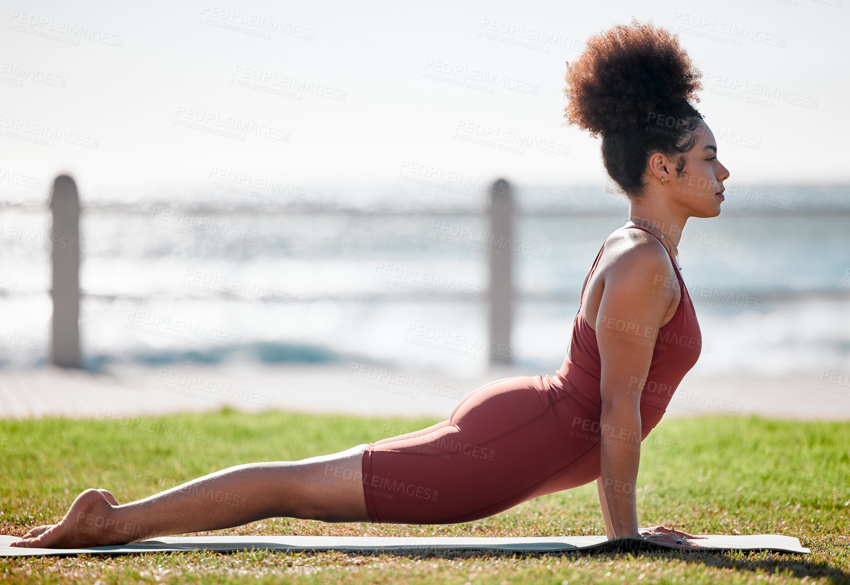 Buy stock photo Yoga, fitness and black woman stretching on grass for healthy lifestyle, body wellness and cardio workout. Sports, pilates training and girl doing meditation, cobra stretch and exercise for peace