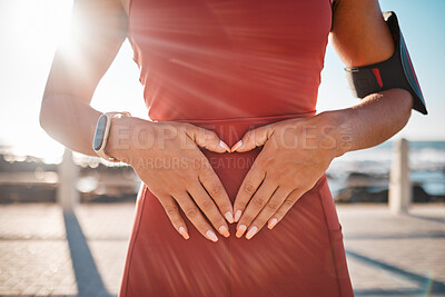 Buy stock photo Heart hands, fitness runner and black woman by the sea with emoji hand sign for exercise. Workout, running training and athlete outdoor in the summer sun and loving gesture on stomach for self love 