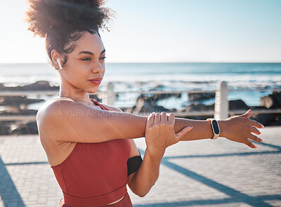 Buy stock photo Stretching, fitness and woman with music for running, exercise and cardio in California. Ready, warm up and runner girl thinking of a workout start with audio for motivation while training by the sea