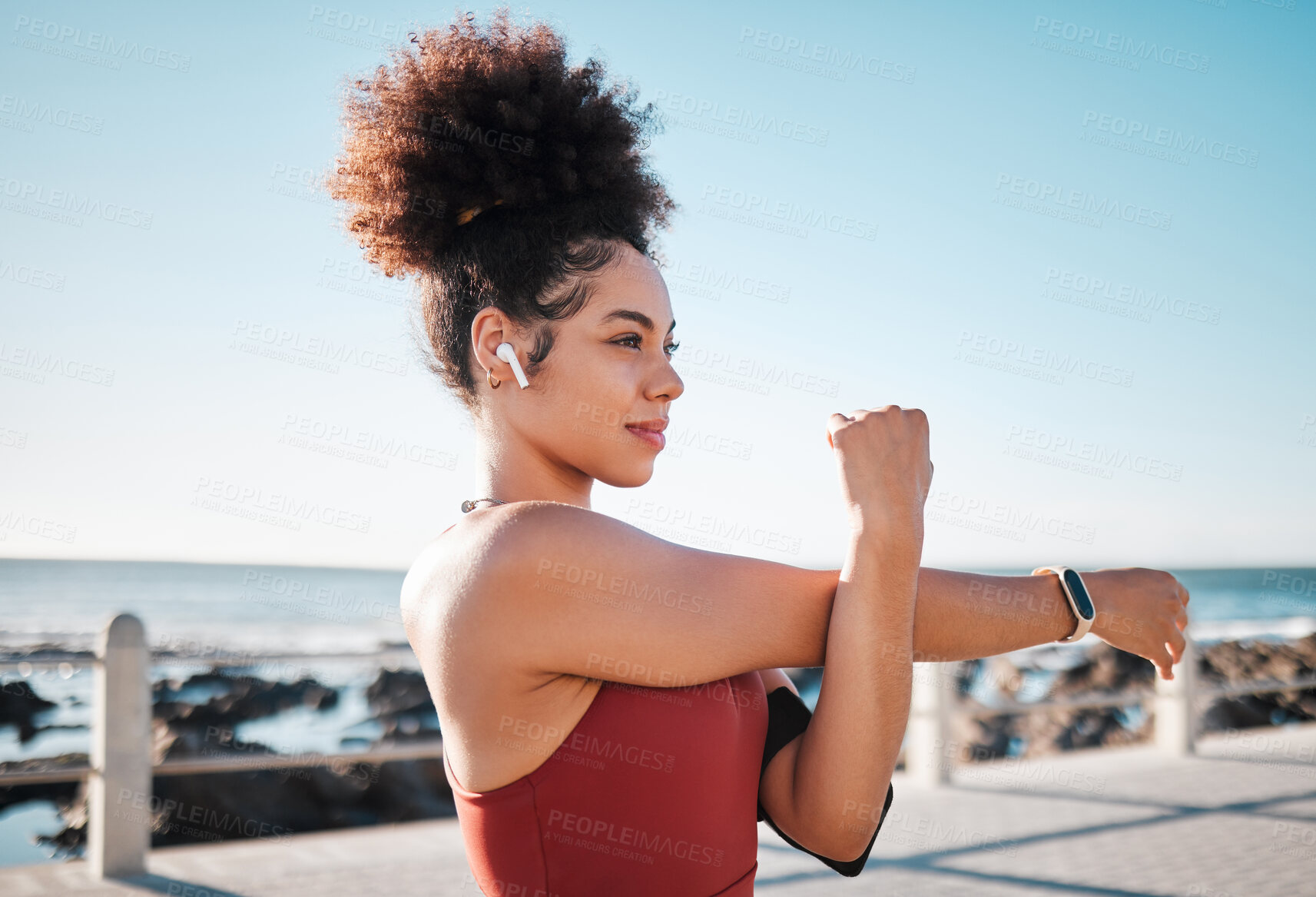 Buy stock photo Stretching, start and woman with music for running, exercise and cardio in California. Ready, warm up and runner girl thinking of a workout with audio for motivation while training by the sea