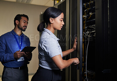 Buy stock photo Server room, engineer teamwork and woman opening panel for maintenance or repairs at night. Cybersecurity, programmers and female with man holding tablet for software or networking in data center.