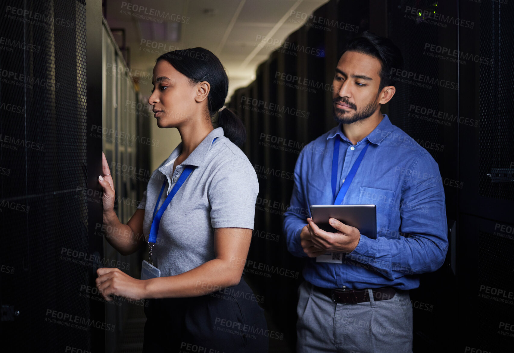 Buy stock photo Engineer, server room teamwork and woman opening panel for maintenance or repairs at night. Cybersecurity, programmers and female with man holding tablet for software or networking at data center.