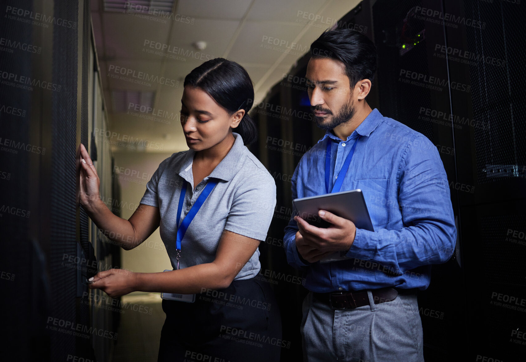 Buy stock photo Engineer teamwork, server room and woman opening panel for maintenance or repairs at night. Cybersecurity, programmers and female with man holding tablet for software or networking at data center.