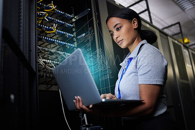 Buy stock photo Laptop, network and data center with a black woman it support engineer working in a dark server room. Computer, cybersecurity and analytics with a female programmer problem solving or troubleshooting