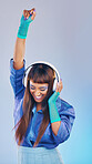 Future, dance and woman with headphones, celebration and excited on studio background. Fashion, female dancer and lady with trendy outfit, edgy and achievement with girl, groove and streaming music