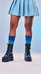 Boots, gen z fashion and legs of a young women in a studio with rock and pastel punk aesthetic. Isolated, blue background and colorful clothes of a person with creative cyberpunk and unique clothing 