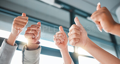 Buy stock photo Hands, thumbs up and collaboration with a business team in celebration together at the office from below. Winner, teamwork or gesture with a man and woman employee group celebrating at work closeup