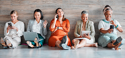 Buy stock photo Collaboration, technology and diversity with a business team sitting on the floor in their office for work. Teamwork, communication and corporate design with a woman employee group working together