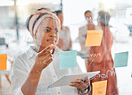 Planning, thinking or black woman for brainstorming on tablet with sticky notes, planning or creative idea on glass wall. Focus, teamwork or business meeting with writing, reading or work schedule