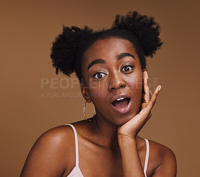 Beauty, skincare and portrait of shocked black woman with hand in face isolated on brown background. Surprise, wow and facial cosmetics or natural makeup for healthy, glowing skin on model in studio.