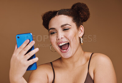 Buy stock photo Phone, selfie and face of woman with smile on brown background for wellness, fashion and makeup. Wow, video call and happy girl influencer on smartphone for social media, internet and online post