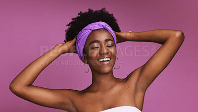 Buy stock photo Skincare, beauty and happy with a model black woman on a pink background in studio for natural care. Face, hair and headband with an attractive young female posing to promote cosmetic treatment