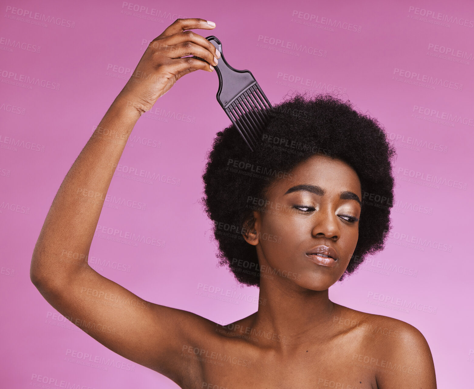 Buy stock photo Black woman, hairstyle or afro brushing on beauty studio background in relax grooming routine, texture maintenance or wellness. Model, comb or natural hair growth and skincare makeup on isolated pink