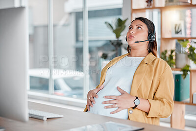 Buy stock photo Office, pregnancy and woman with hand on stomach, exhausted, stress and pain in call center with headset. Burnout, pain and tired, pregnant telemarketing consultant doing breathing exercise at desk.