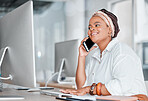 Communication, conversation and black woman on a phone call while working on a computer. Contact, connection and African employee talking on a mobile while typing on a pc for information at work