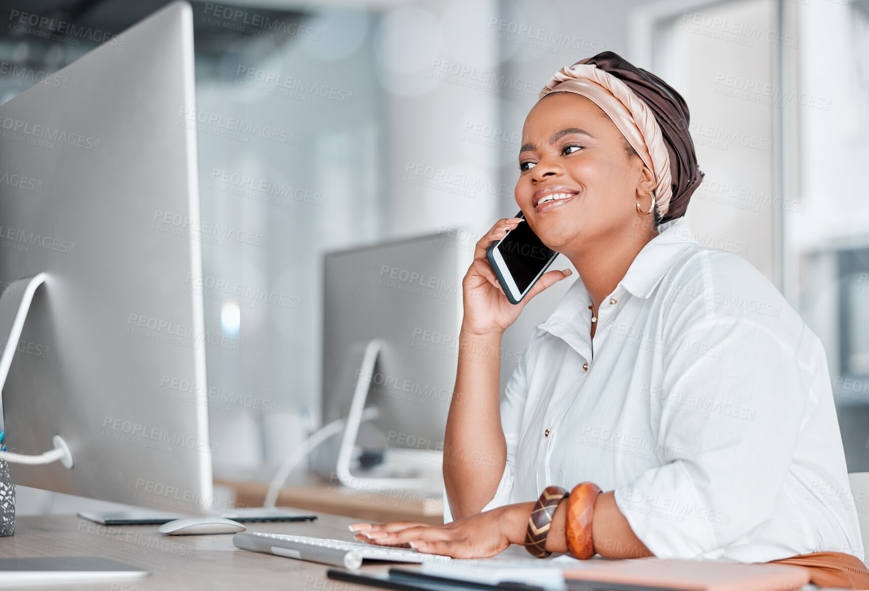 Buy stock photo Communication, conversation and black woman on a phone call while working on a computer. Contact, connection and African employee talking on a mobile while typing on a pc for information at work