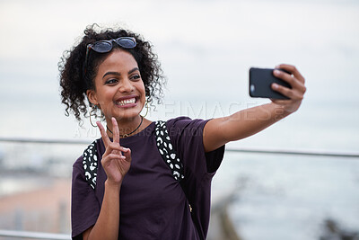 Buy stock photo Selfie, peace sign and smile of black woman in city taking pictures for happy memory. Travel, street and female with v hand gesture, having fun and enjoying time while taking photo for social media.