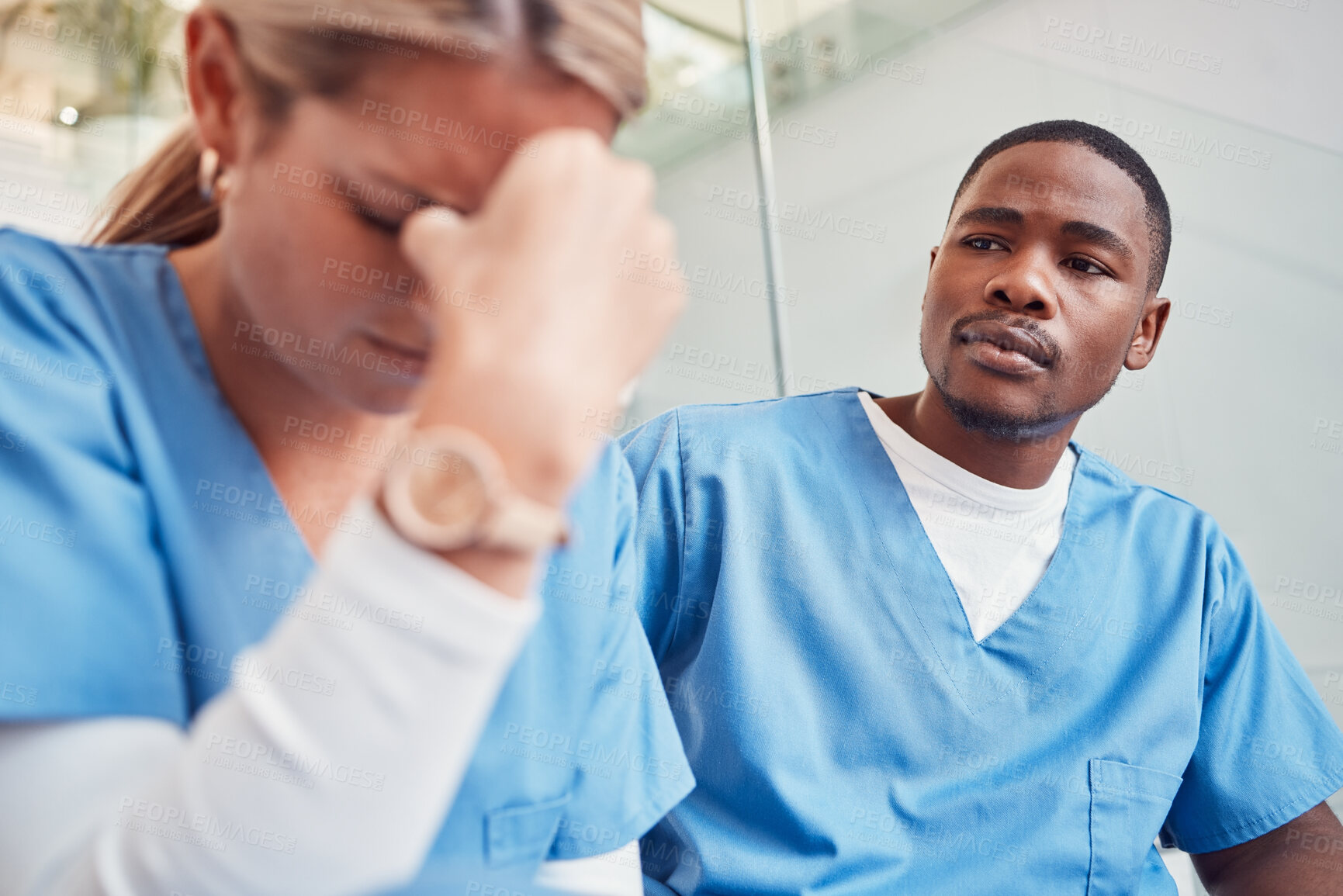 Buy stock photo Healthcare, collaboration or loss and a sad nurse in the hospital with a man colleague showing compassion. Medical, death and insurance with a black male medicine professional consoling a friend