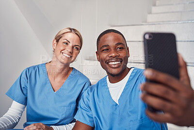 Buy stock photo Healthcare, selfie and staff with happiness, hospital and celebrate achievement, interns and cheerful together. Medical professionals, woman and black man with smartphone, taking pictures and joyful