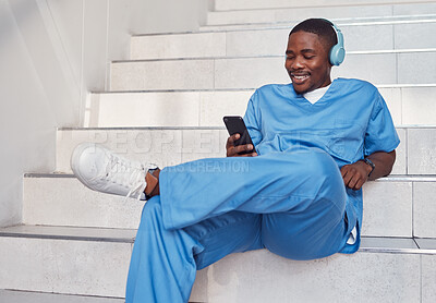 Buy stock photo Doctor, phone and stairs for relaxing, communication or video call outside hospital for health advice. Happy black man nurse smiling in healthcare with smartphone and headset for telemedicine