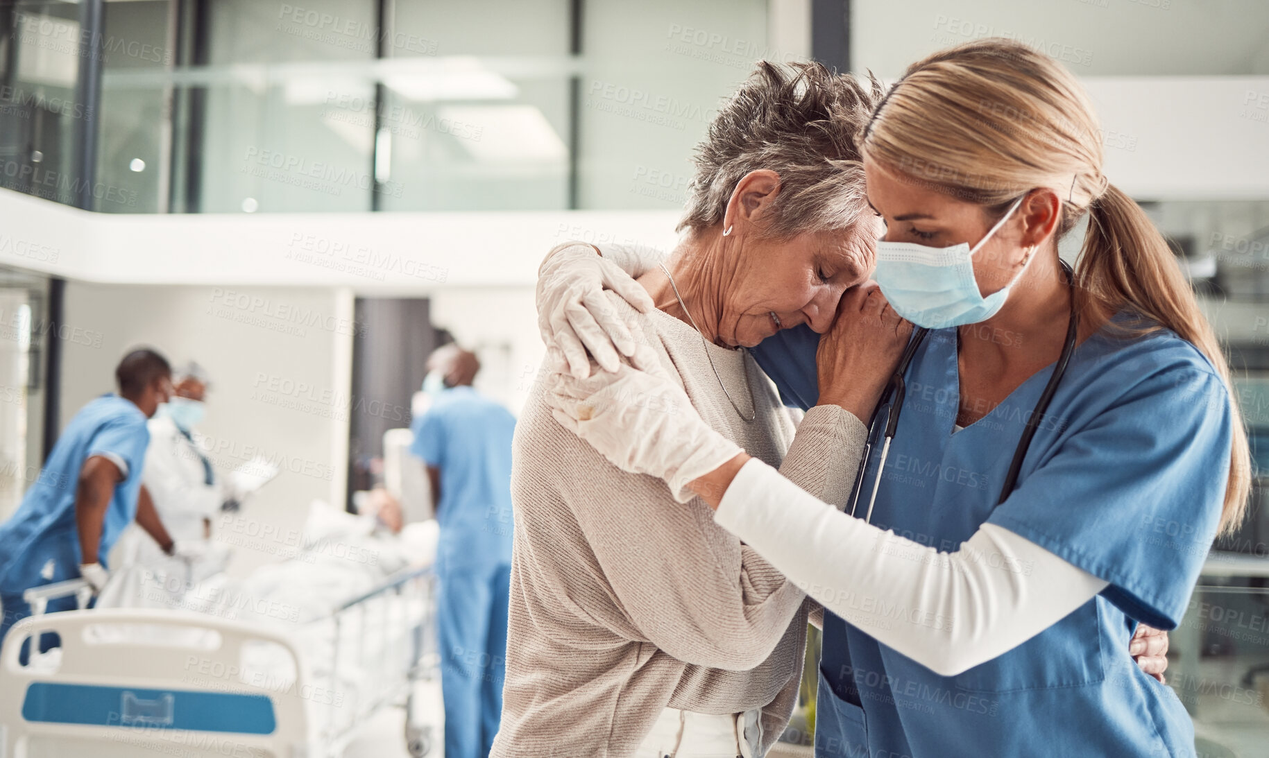 Buy stock photo Doctor, hug and sad senior woman in hospital for support, comfort and empathy for surgery of husband. Medic, face mask and embrace wife of patient with covid 19 emergency in clinic with solidarity