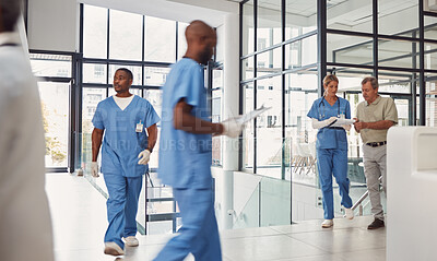 Buy stock photo Healthcare, insurance and nurse with a people walking in a busy hospital for treatment or diagnosis. Medical, diversity and support with a medicine professional team at work in a health clinic