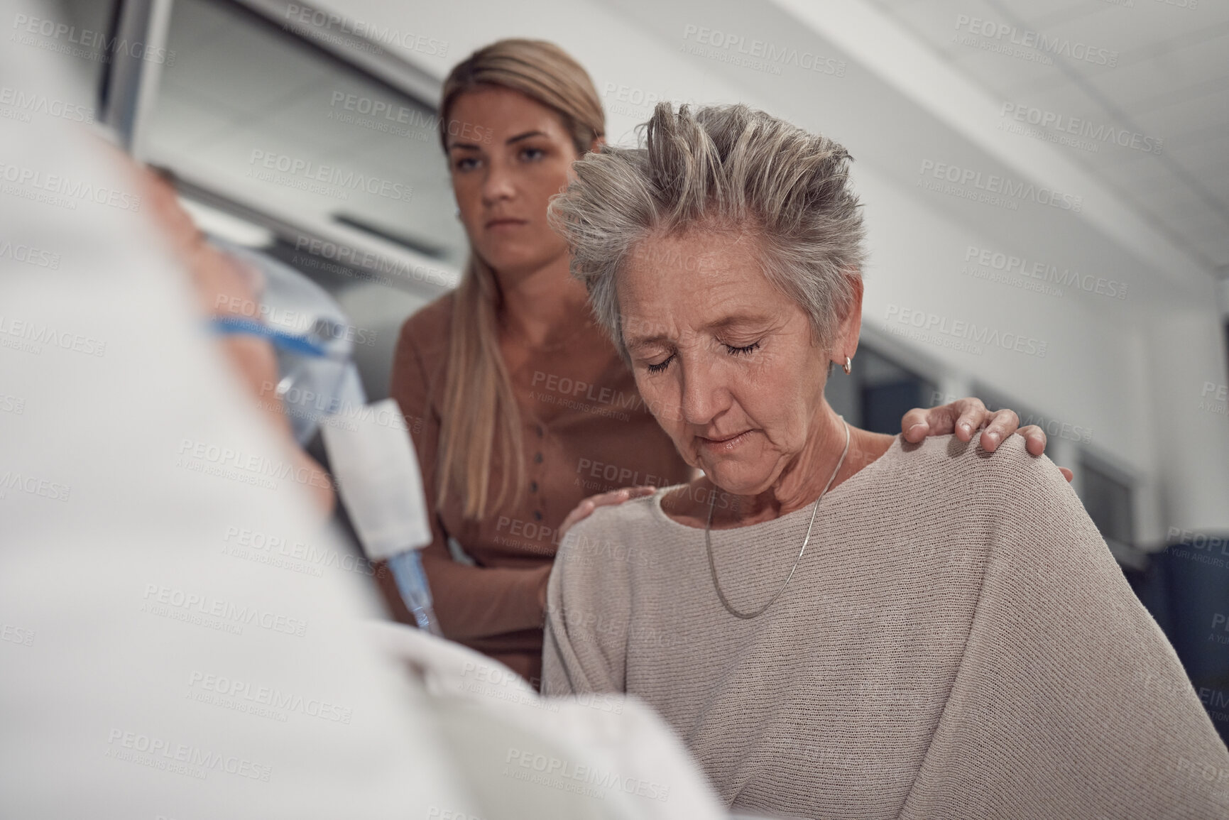 Buy stock photo Sad woman visit her sick husband in hospital with the support and comfort from their daughter. Healthcare, love and senior female sitting and praying with her ill man with cancer in a medical clinic.