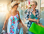 Friends, shopping and senior women outdoor, summer vacation or journey for adventure with happiness. Mature females, happy elderly ladies or purchase clothes with smile, retirement or holiday reunion