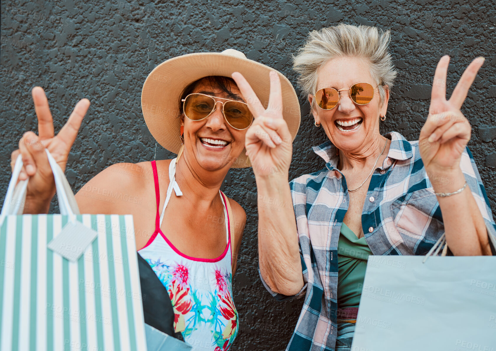 Buy stock photo Peace, fun and portrait of women shopping in the city for bonding, holiday and weekend fun. Carefree, excited and elderly friends with bags after a sale, retail discount and ecommerce in town