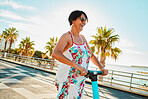 Woman riding electric scooter, happy retirement and summer ride at tropical island beach resort for vacation. City, street and eco friendly transport, fun for grandma on escooter on holiday in Hawaii