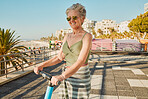 Electric scooter, retirement and woman on summer ride at tropical island beach resort for happy vacation. City, street and eco friendly transport, fun for grandma riding escooter on holiday in Hawaii