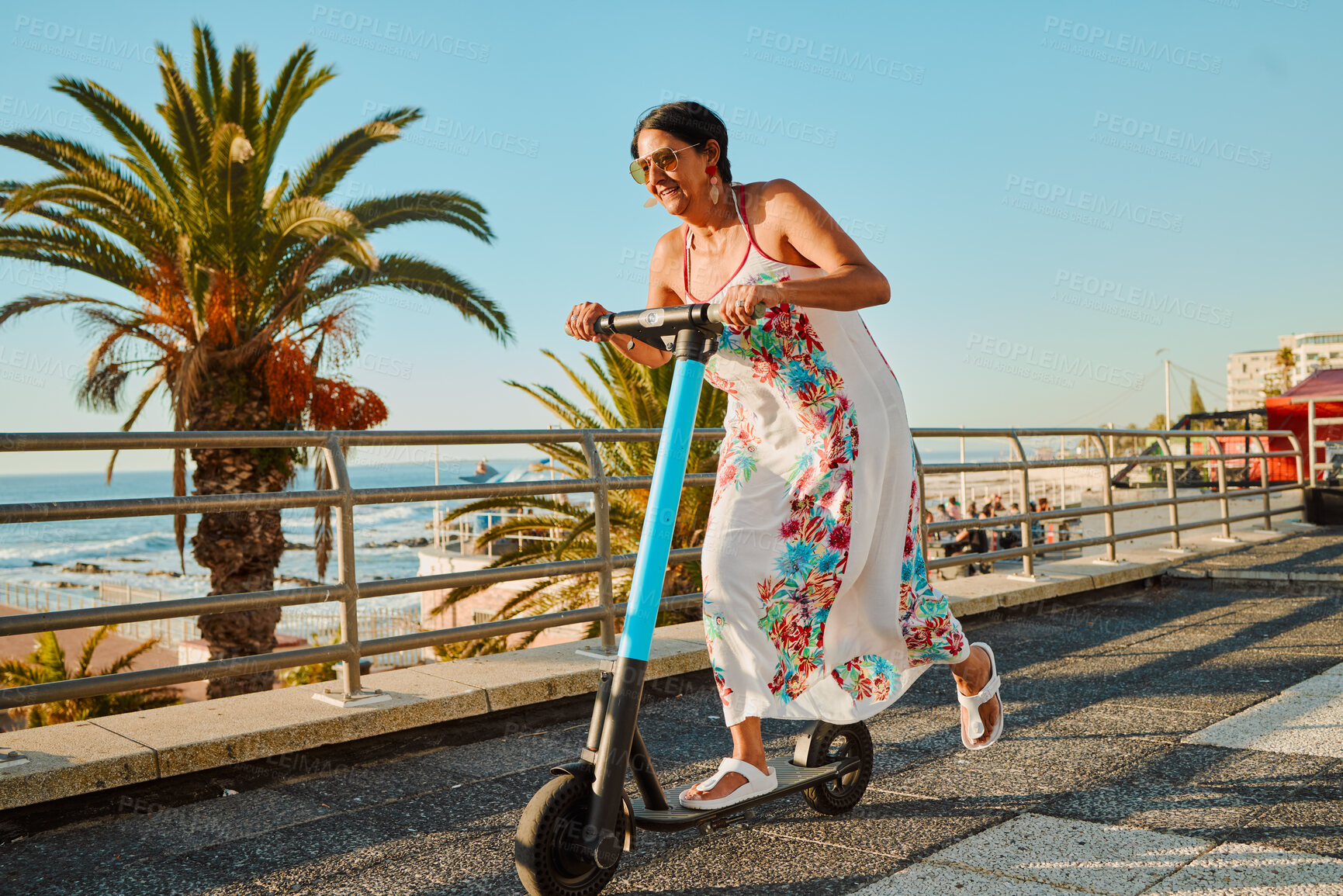 Buy stock photo Senior woman on scooter, eco friendly travel and adventure in Miami street, summer and fun in sun with happiness. Excited, ebike and sustainable transportation, retirement and clean carbon footprint 