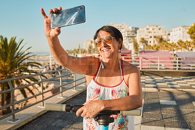 Buy stock photo Vacation, selfie and happy senior woman in retirement riding a scooter on the beach promenade. Happiness, smile and elderly female taking picture while having fun on holiday or weekend trip in Mexico