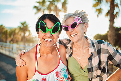 Buy stock photo Sunglasses, funny and senior women hug, happy and laugh on vacation, trip or crazy summer holiday. Face, fun friends and elderly lady embrace while travel, bond or enjoy retirement together