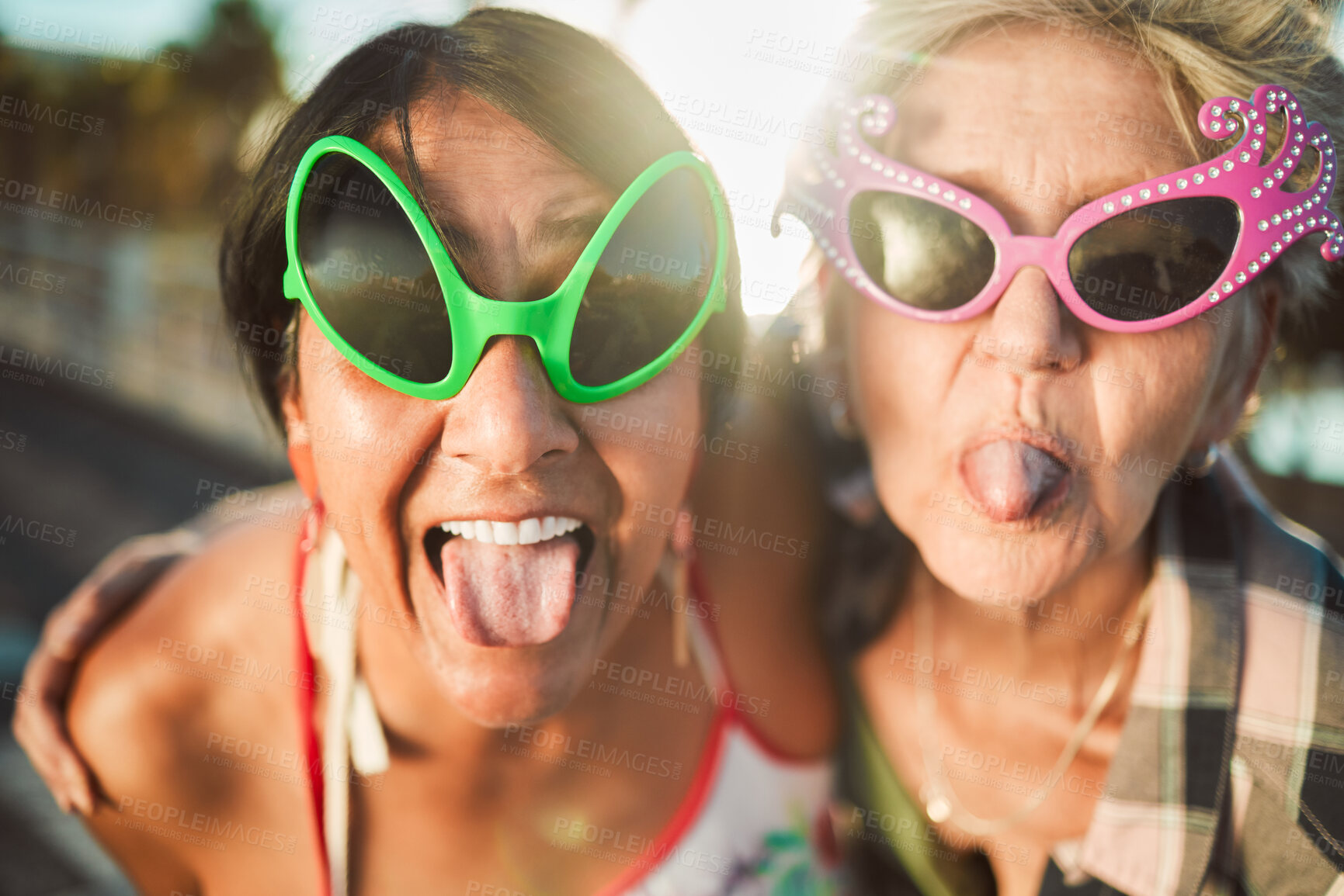Buy stock photo Funny, selfie and tongue out by senior women with sunglasses outdoors for travel, break and bonding on blurred background. Emoji, face and crazy elderly friends pose for photo, profile picture or fun