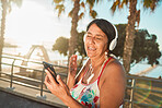 Summer, music and senior woman at beach with headphones on weekend, holiday and Miami vacation. Travel, retirement and happy elderly female listening to song, radio and audio for calm, fun and relax