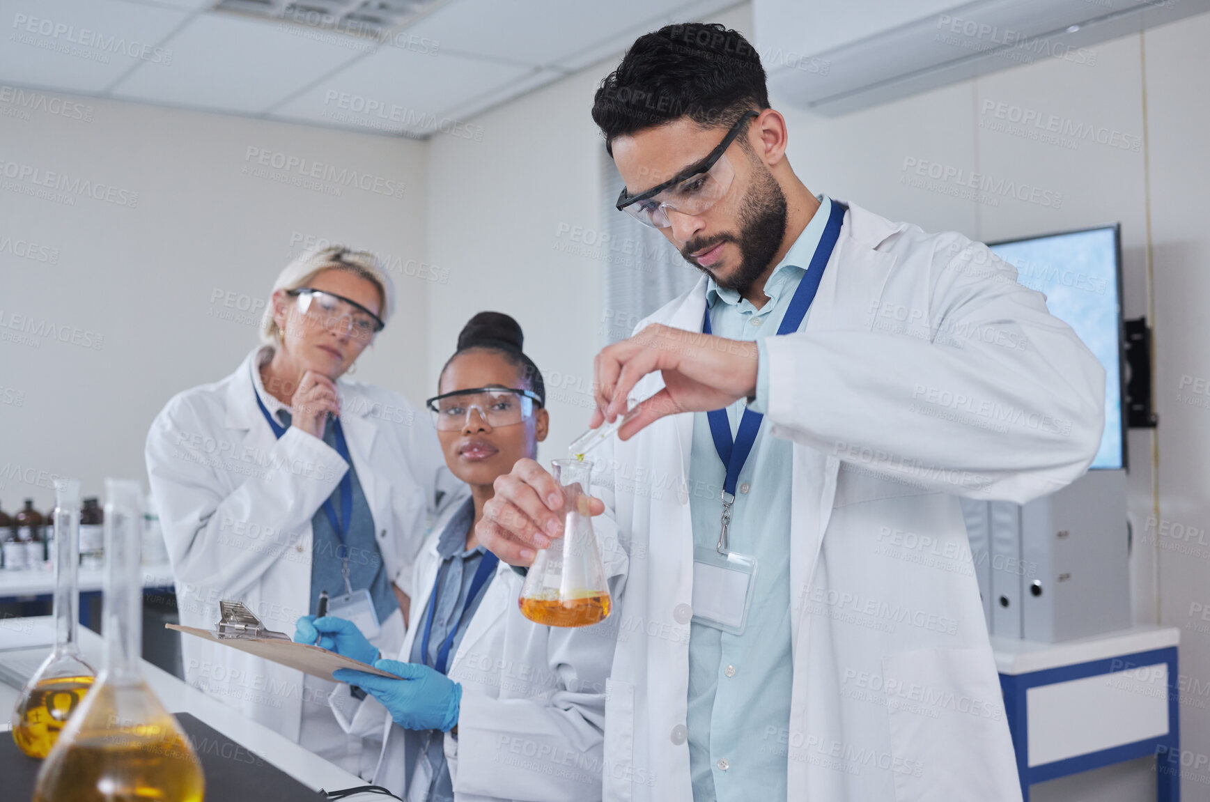 Buy stock photo Science, laboratory and team with liquid in beaker for medical research, lab study and vaccine development. Biotechnology, chemistry and scientists with sample for analysis, test and experiment